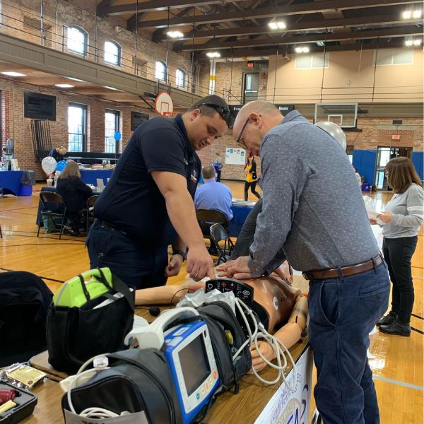 EMS Paramedic Ramos demonstrating some of our training equipment at city health fair